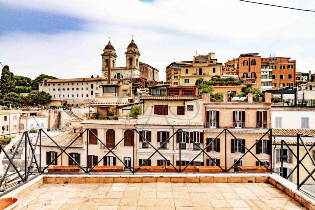 Terrazza panoramica di un attico di lusso in affitto a Roma, con vista sui tetti del centro storico.