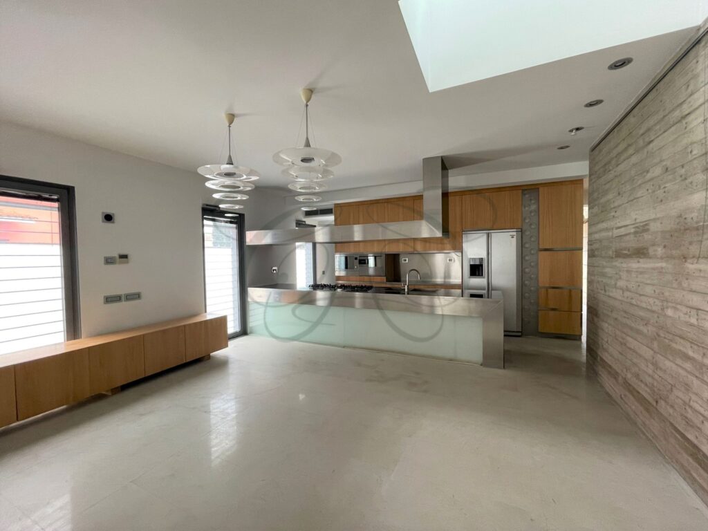 The unique sculptural staircase of a Brutalist design villa for sale by Class & Country Homes.