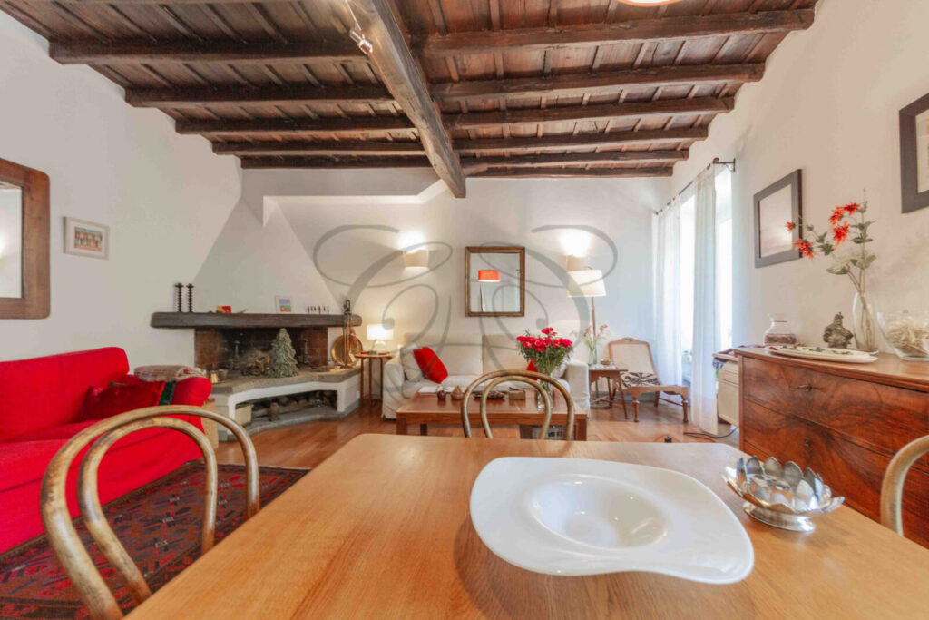 Living room with exposed wooden beams in a historic apartment rented by Class & Country Homes in Rome.