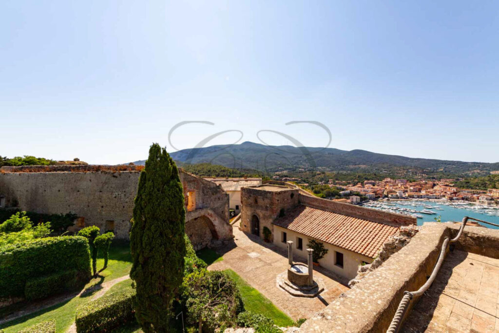 Giardino privato con patio e cipressi, immobile in vendita nella Rocca di Porto Ercole.