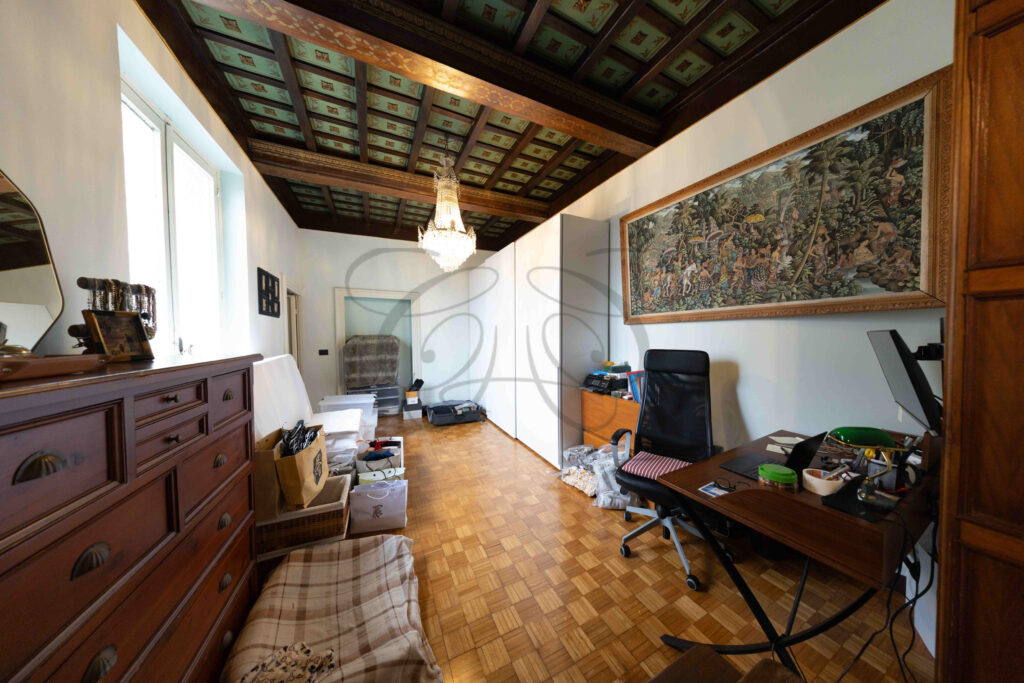 Large versatile room with painted coffered ceiling and antique tapestry, penthouse for rent Rome historic center.