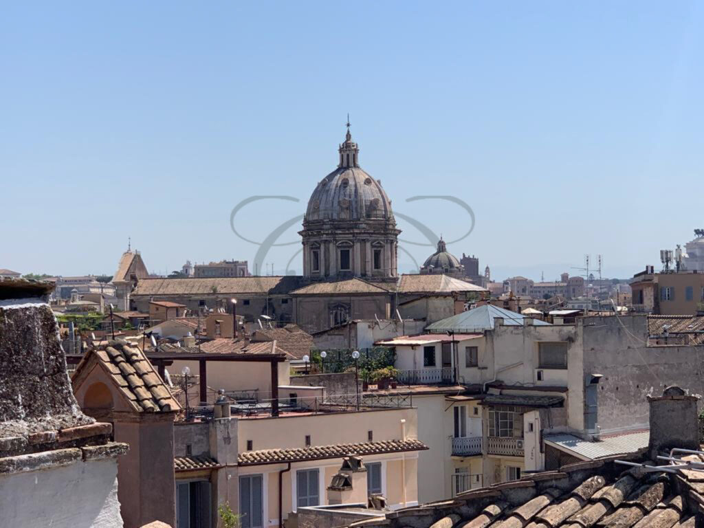 Panoramic view of Rome's rooftops, domes, and monuments from the penthouse for rent in the historic center.