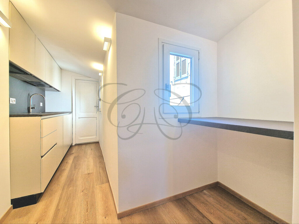 The living room and open kitchen area of a designer attic apartment for rent near Piazza Navona, Rome.