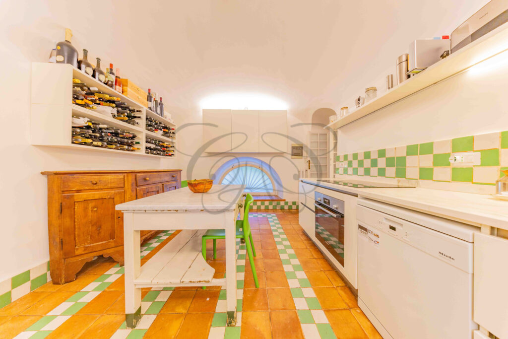 Kitchen showing built-in wine rack and central island - Class & Country Homes.