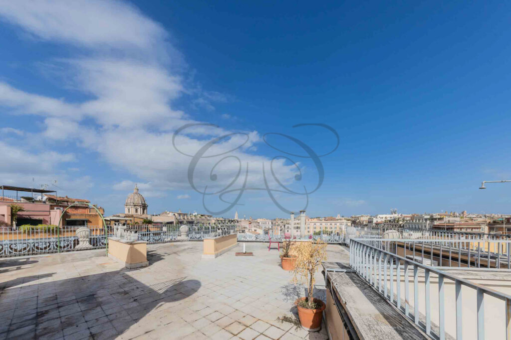 The expansive rooftop terrace under a blue sky, penthouse for rent Rome - Class & Country Homes.