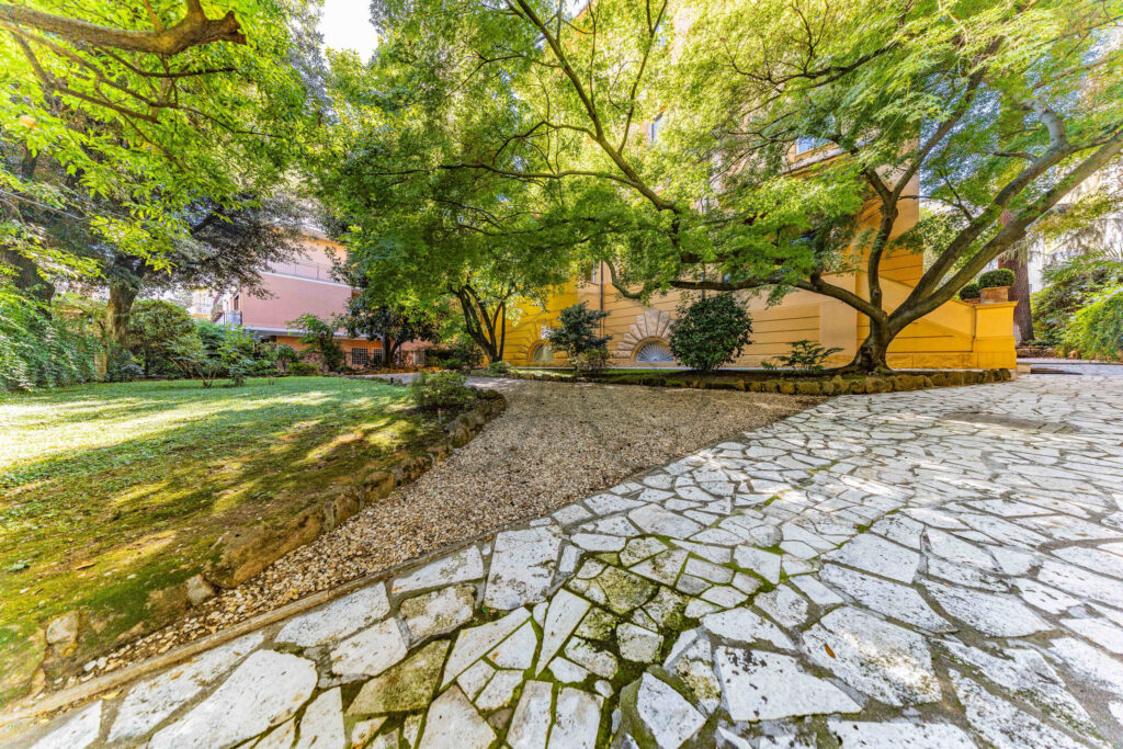 Stone pathway and bench in the tranquil private garden - Class & Country Homes.