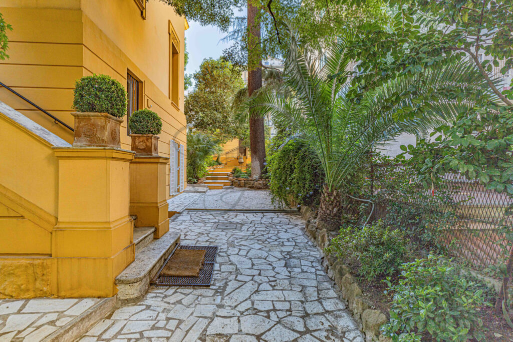 Stone pathway leading through the lush private garden - Class & Country Homes.