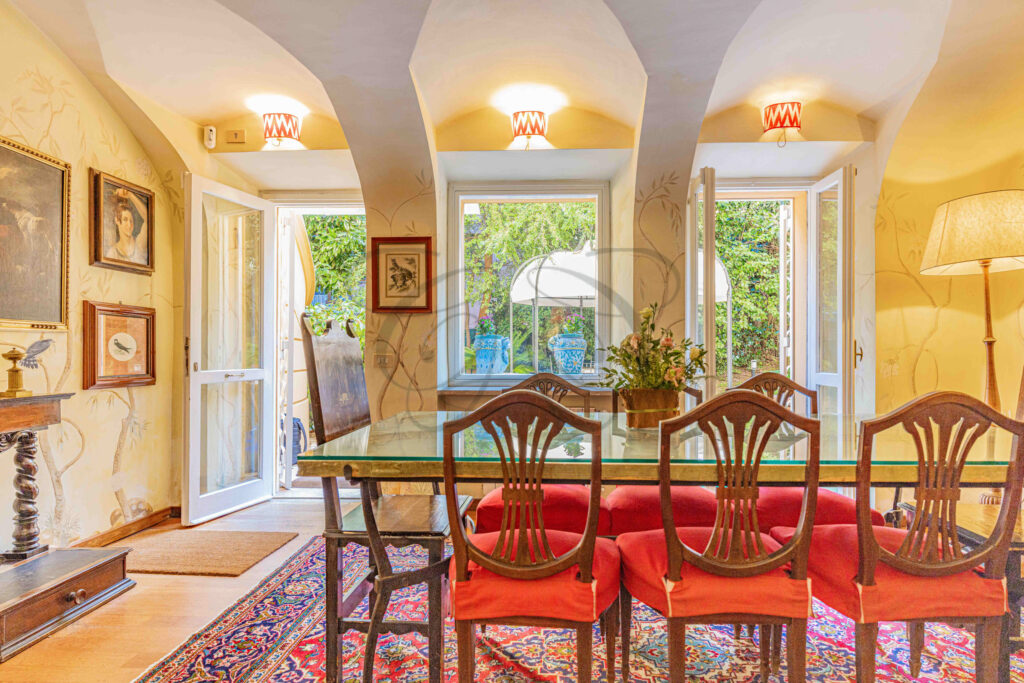 Dining room with arched doorway leading to the private garden - Class & Country Homes.