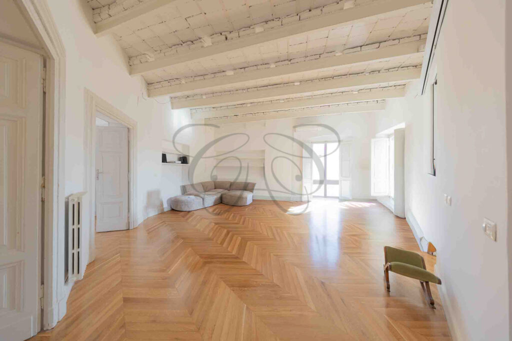 Spacious living room with parquet floors and beamed ceiling in Rome penthouse - Class & Country Homes.