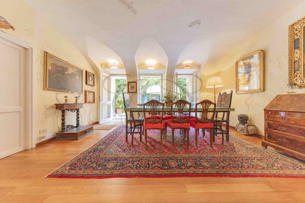 Spacious formal dining room with antique furniture and piano - Class & Country Homes.