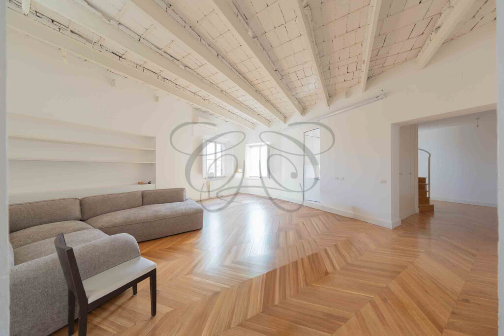 Main living room with sofa and beamed ceiling, luxury penthouse for rent - Class & Country Homes.