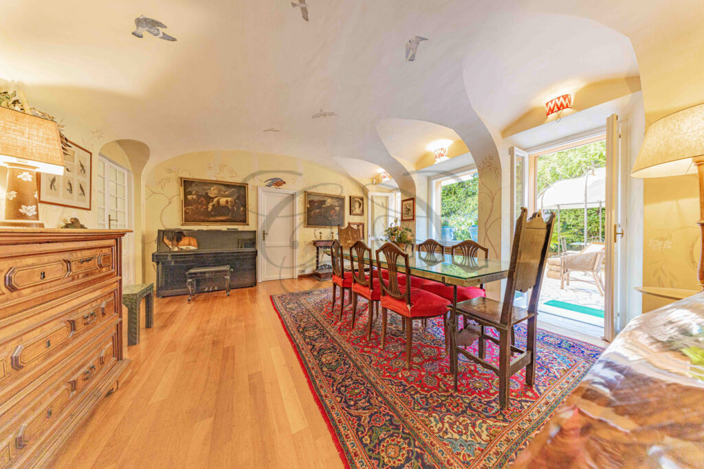 Expansive dining room with multiple arched doorways - Class & Country Homes.