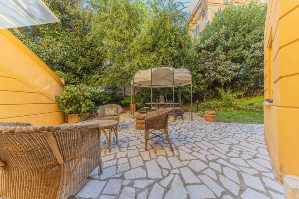 Secluded garden seating area with stone bench under the trees - Class & Country Homes.