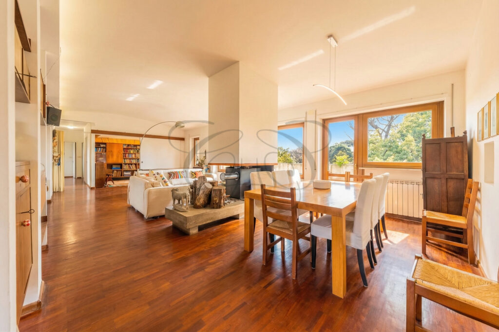 Luxury apartment in Vigna Clara, view of the dining area and fireplace.