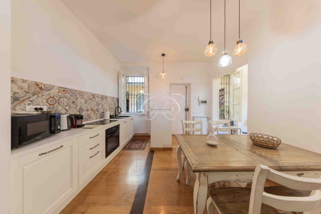 Borgo Vittorio Rome luxury apartment for rent — dining room with open-plan kitchen