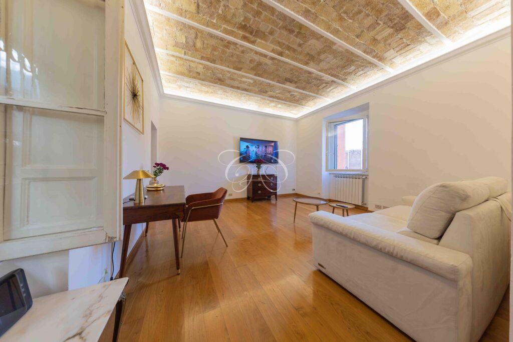 Borgo Vittorio Rome luxury apartment for rent — living room with sofa and television