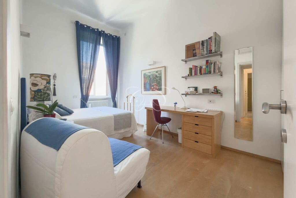 Prati Rome luxury apartment for sale — double bedroom with armchair and desk