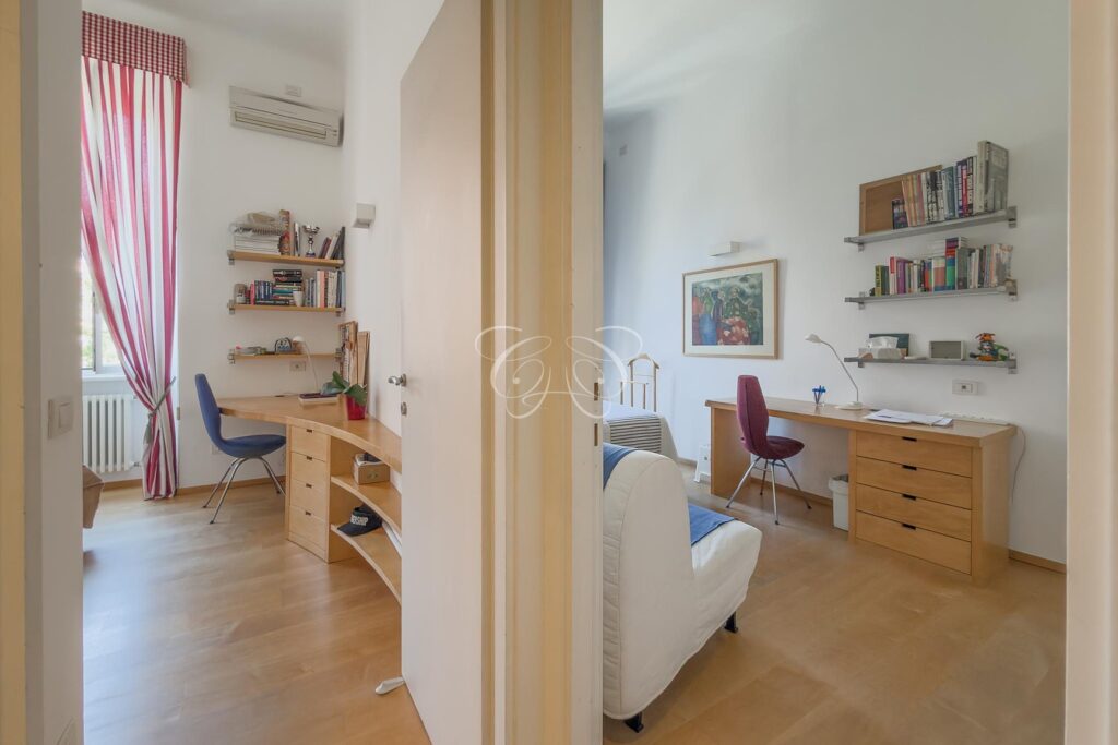 Prati Rome luxury apartment for sale — double bedroom with desk and shelves