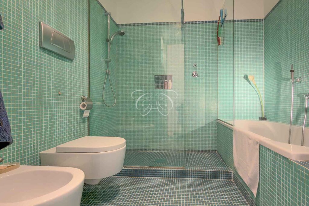 Prati Rome luxury apartment for sale — en suite bathroom with bath and glass-screened shower