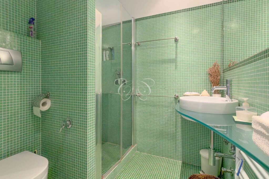Prati Rome luxury apartment for sale — mosaic-tiled bathroom of the suite