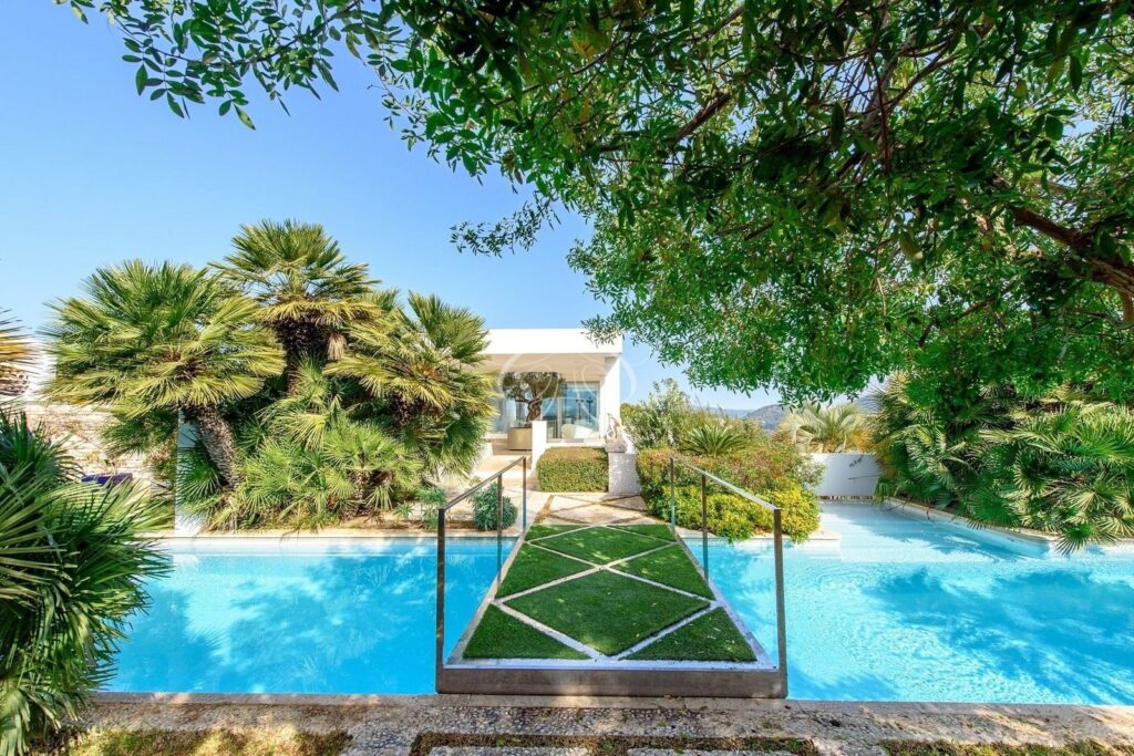Roca Llisa Ibiza luxury villa for sale — pool with lawn walkway
